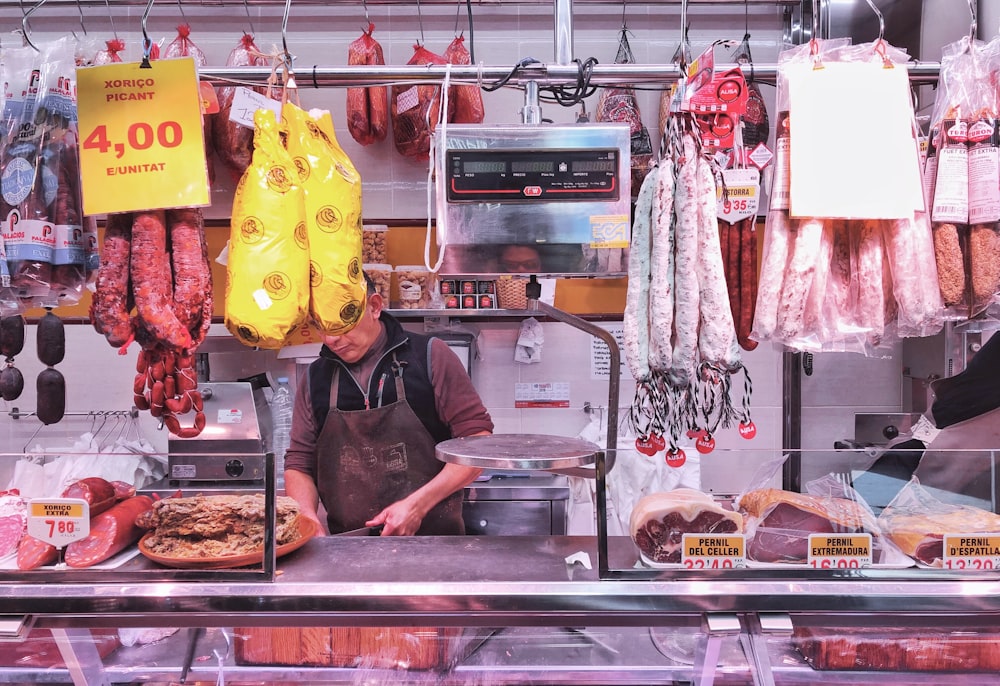 woman in black jacket standing in front of food display counter