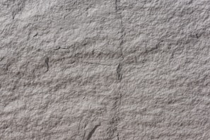 Texturized marble panel with a rough, tactile surface.