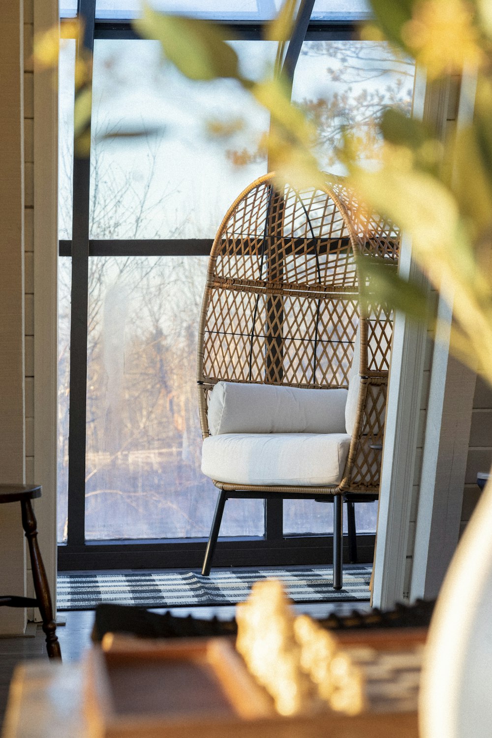 white and black padded chair beside window