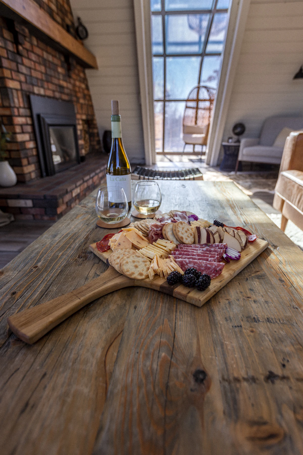 bread and toppings arranged on a wooden table with stuffed dates