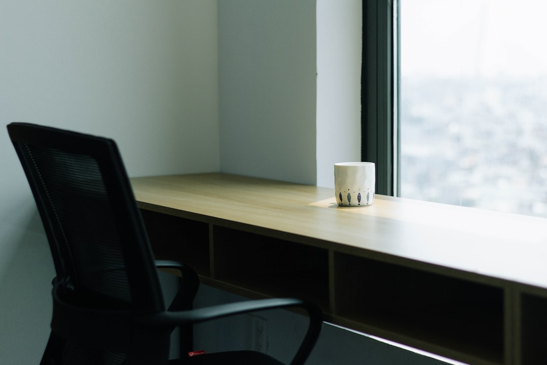 white disposable cup on brown wooden table