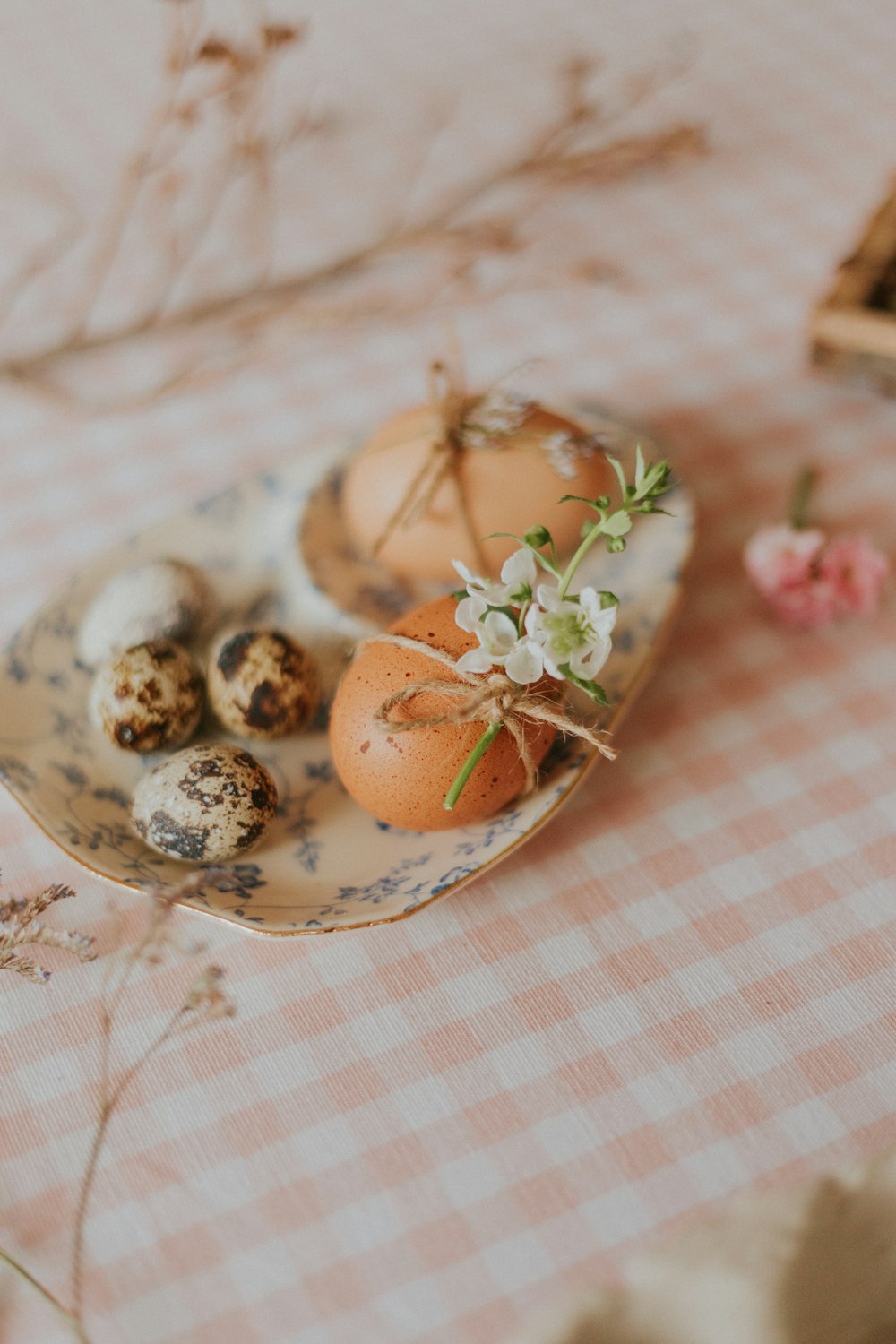 brown and white eggs on white and blue floral ceramic plate