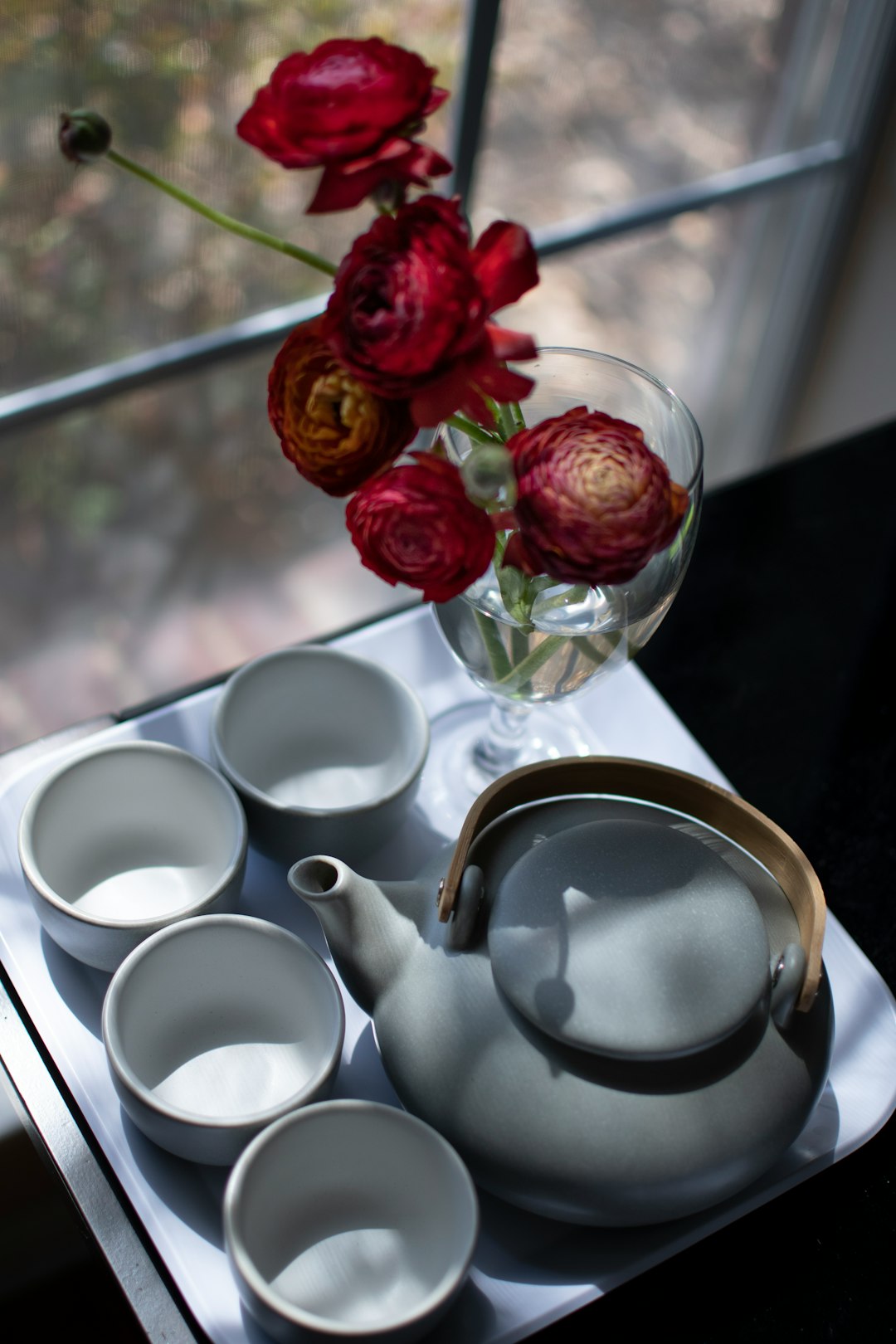 red rose on white ceramic teacup on saucer