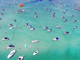 aerial view of boats on sea shore during daytime