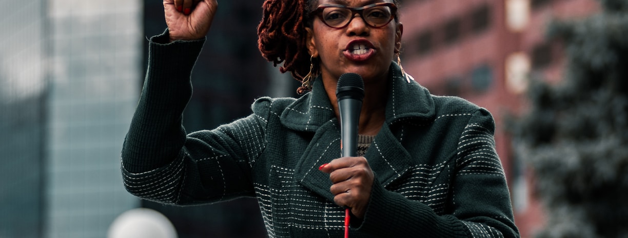 woman in black leather jacket holding her hair