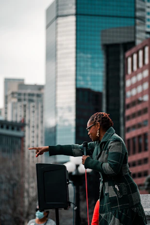 Portrait of a confident Afro-descendant community leader speaking at a local event.