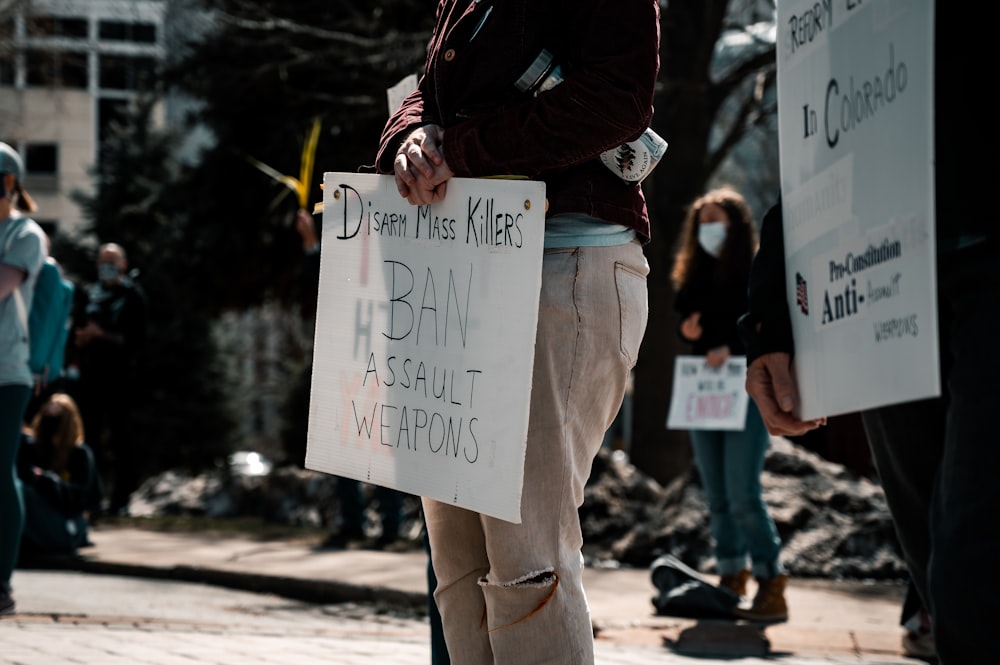 a group of people standing around holding signs