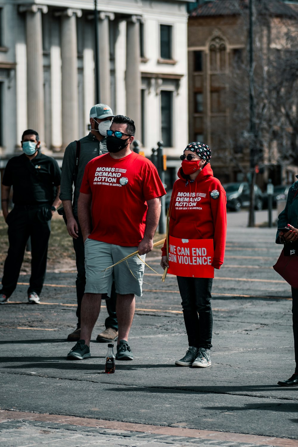 man in red crew neck t-shirt and black pants walking on street during daytime