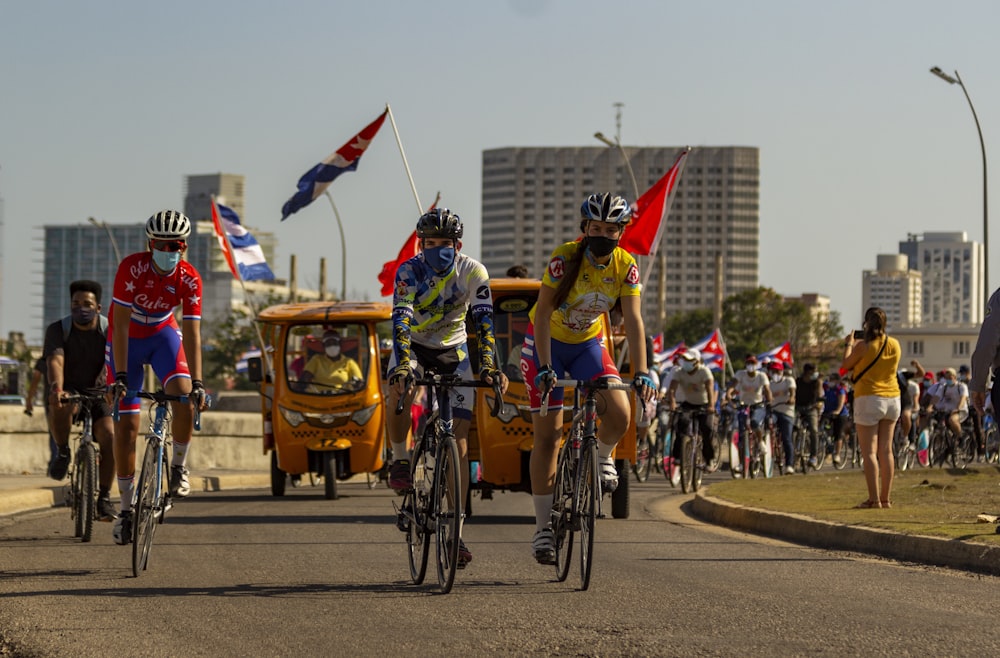 people riding bicycles on road during daytime