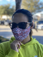Close-up of a person wearing a sleek, colorful aerisana mask outdoors on a sunny day.