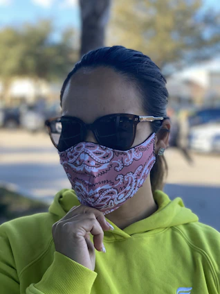 Close-up of a person wearing a sleek, colorful aerisana mask outdoors on a sunny day.