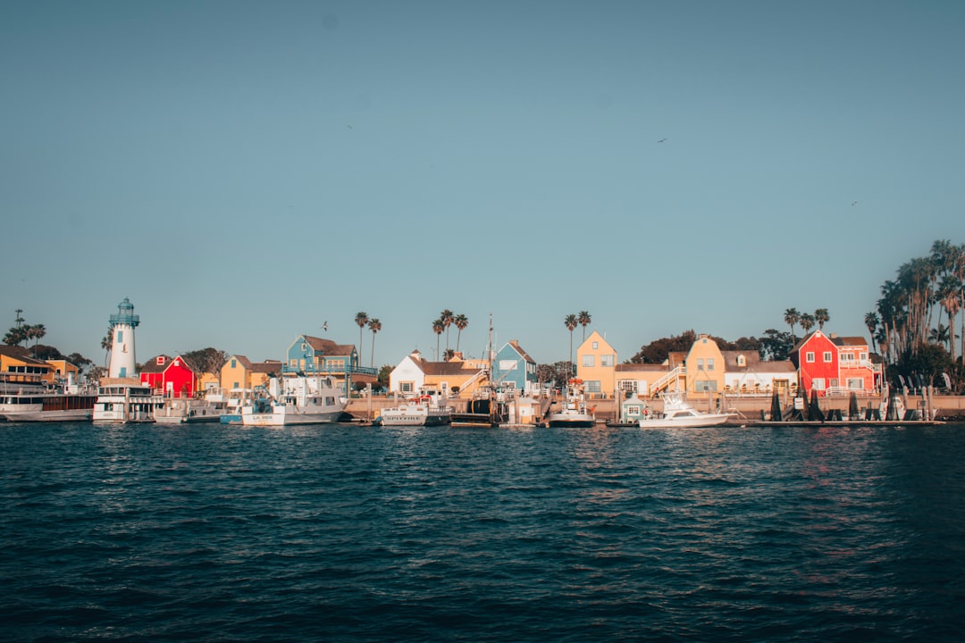 white and brown houses near body of water during daytime