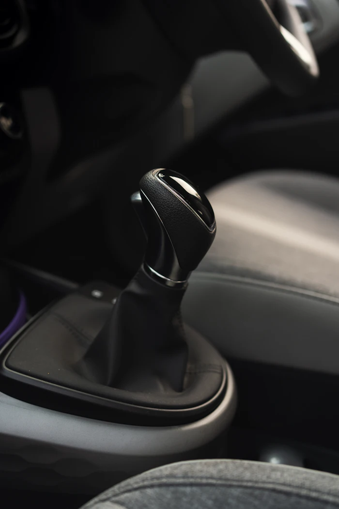 Manual transmission shifter and gaiter in a modern car interior