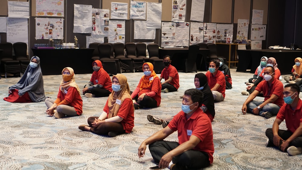 group of people sitting on floor