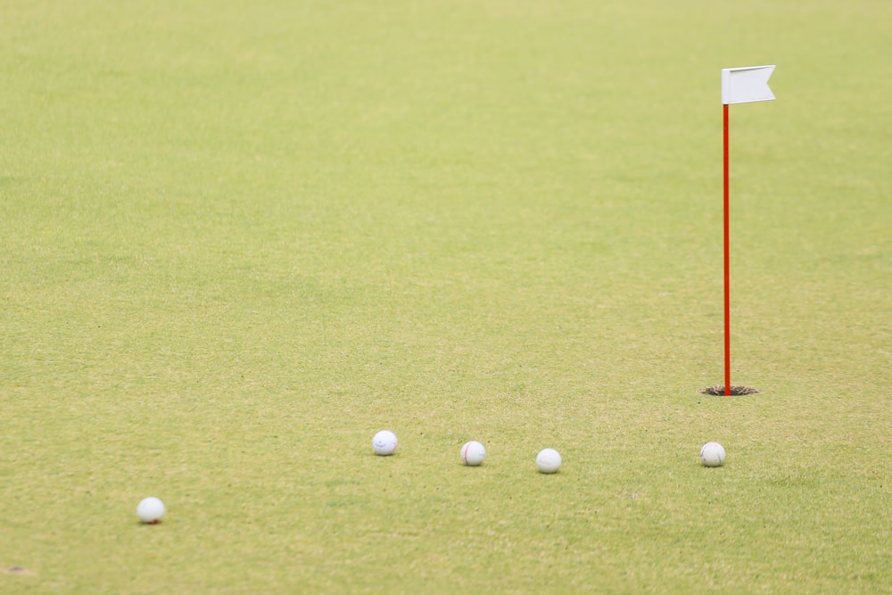 golf ball on green grass field during daytime