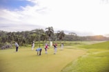 people playing golf during daytime