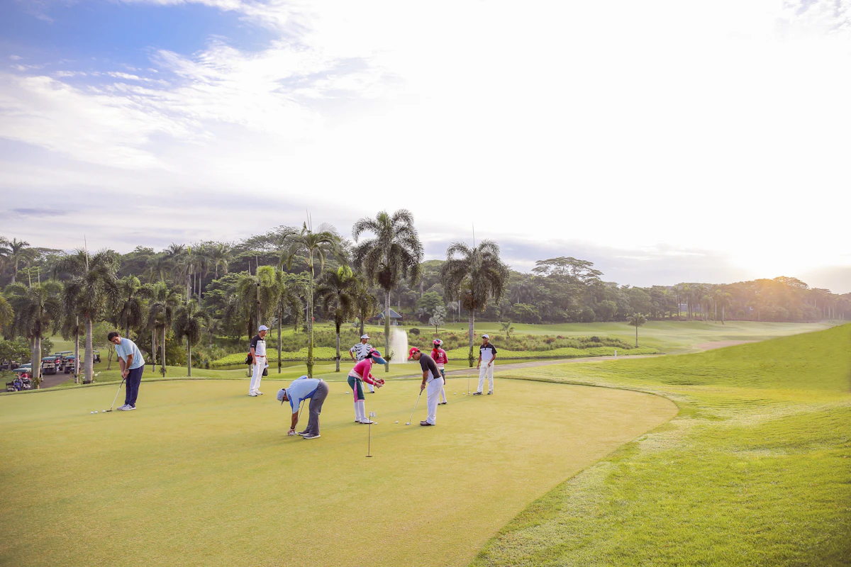 A group of friends enjoying a round of golf together on the green