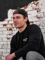 A close-up of a punkyarn sweatshirt with bold graphic details against a gritty city wall.