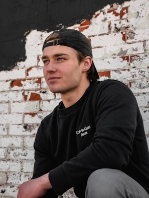 A close-up of a punkyarn sweatshirt with bold graphic details against a gritty city wall.