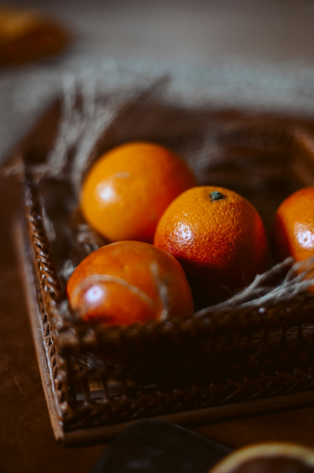 orange fruit on brown woven basket