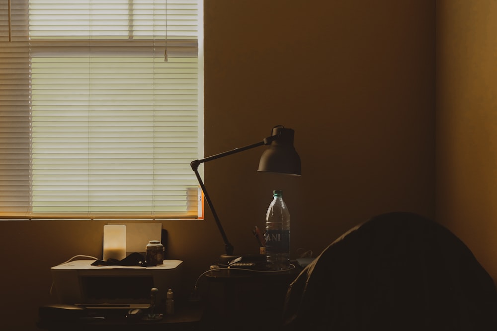 black desk lamp on brown wooden desk