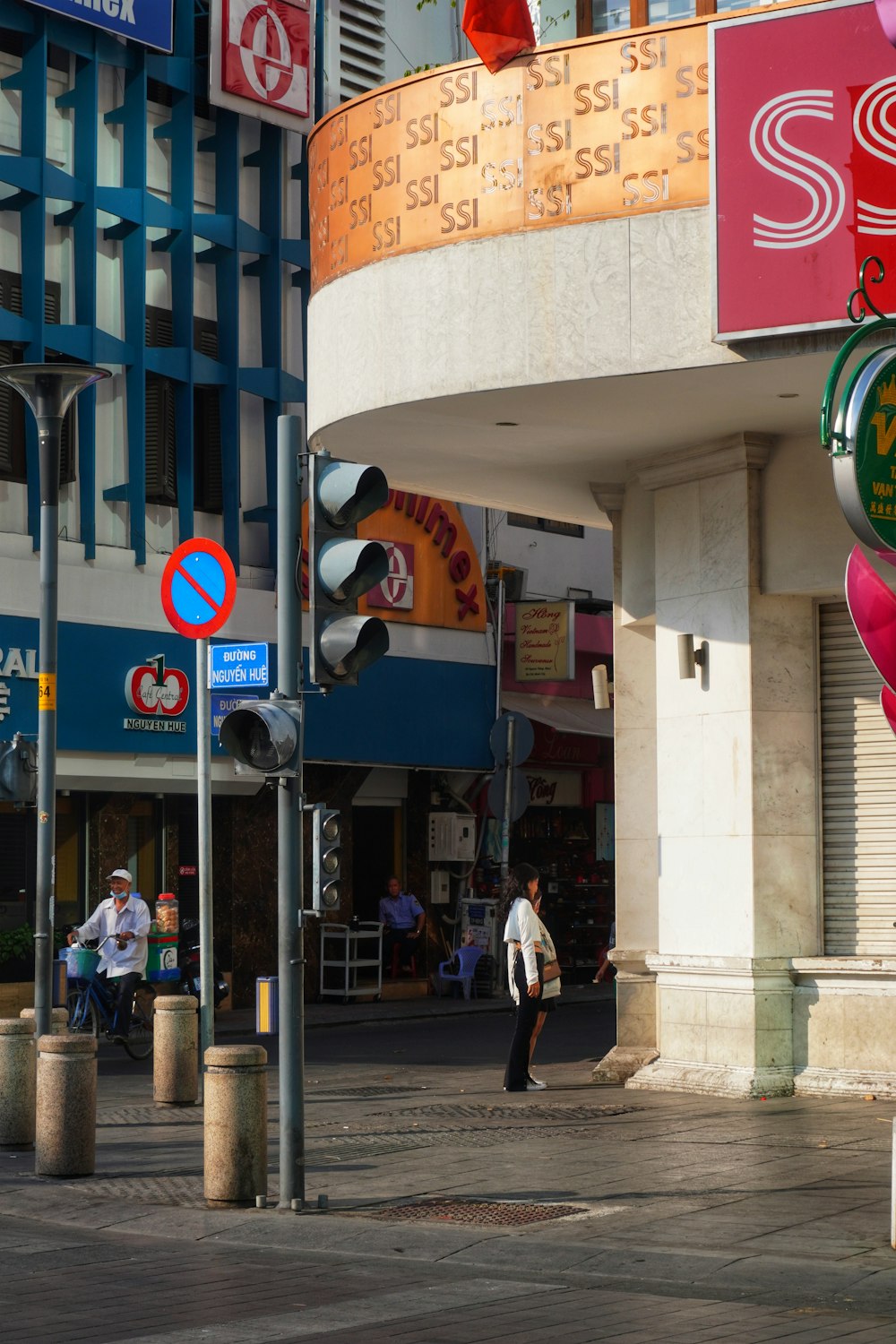 people walking on sidewalk near building during daytime