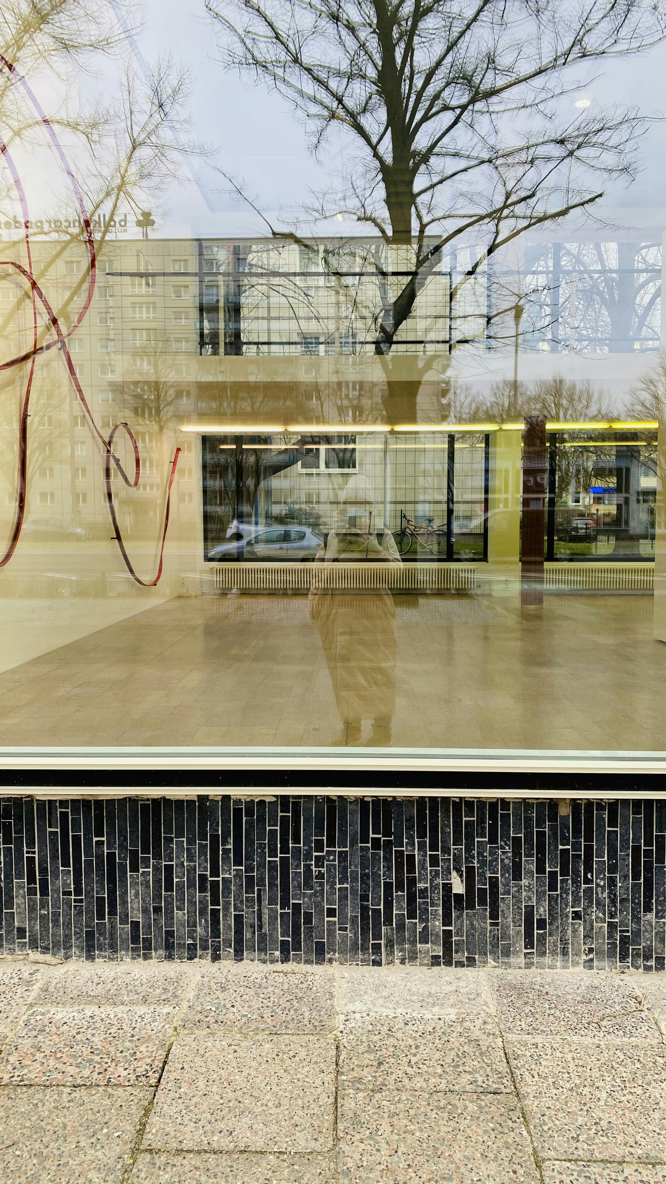 Plain bare glass storefront window with no graphics, muted desaturated look