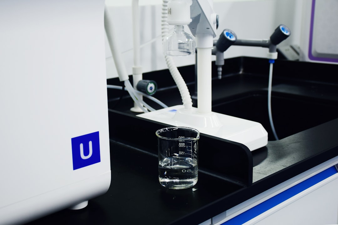clear glass mug beside white and blue electric toothbrush, Ultrapure water purification system in laboratory