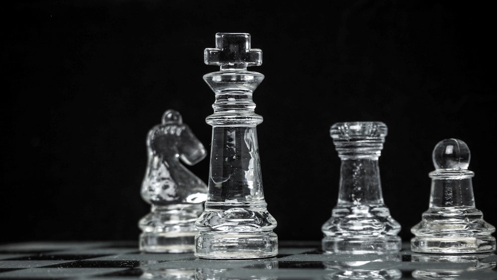 clear glass chess piece on blue table