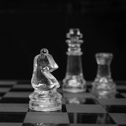 grayscale photo of chess pieces