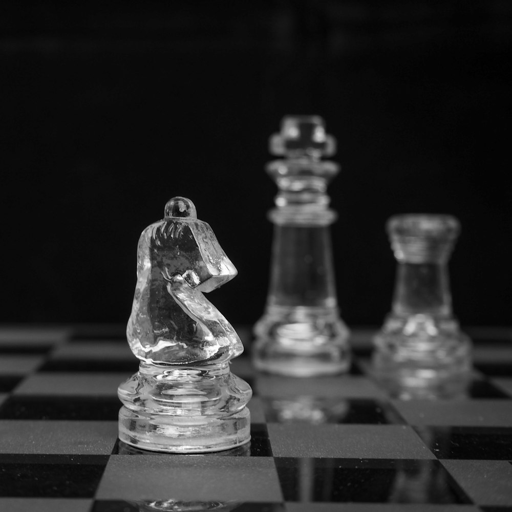 grayscale photo of chess pieces