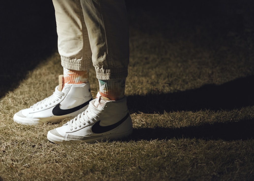 person in white pants wearing white nike sneakers