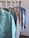 A collection of colorful women's tops displayed on hangers.