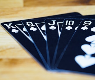 black and white playing cards on brown wooden table