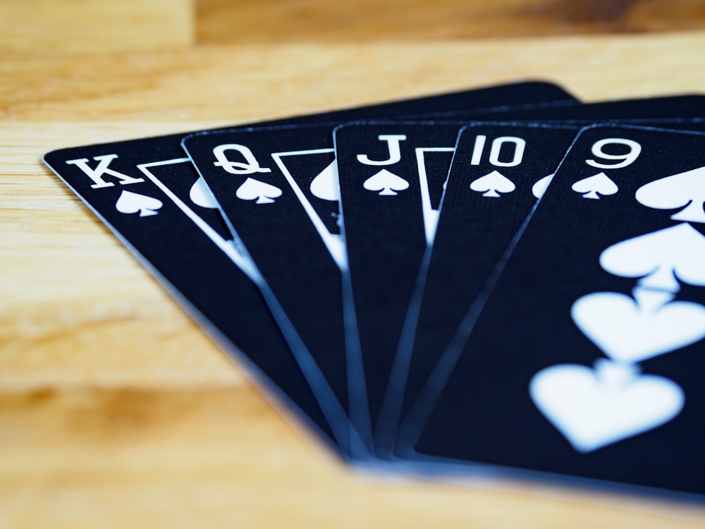 black and white playing cards on brown wooden table
