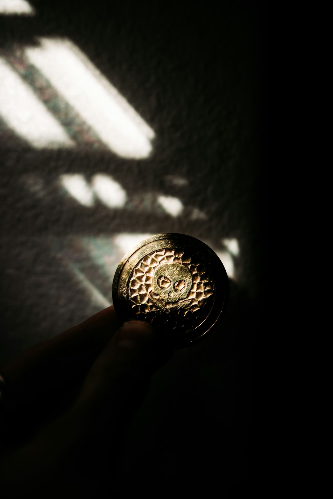 person holding silver round coin