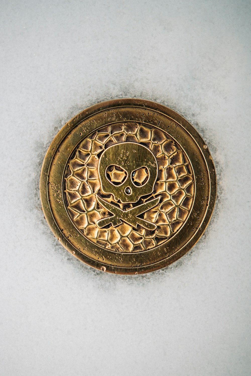 gold round coin on white table