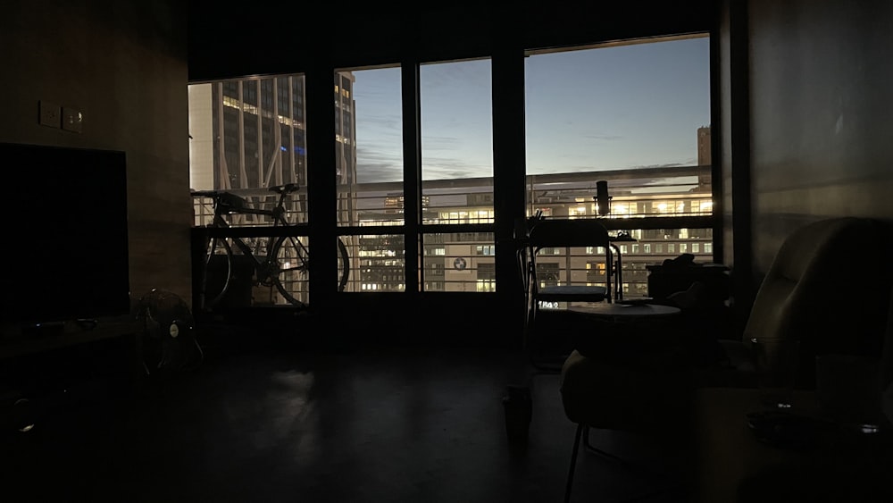 silhouette of people sitting on chair near window during daytime