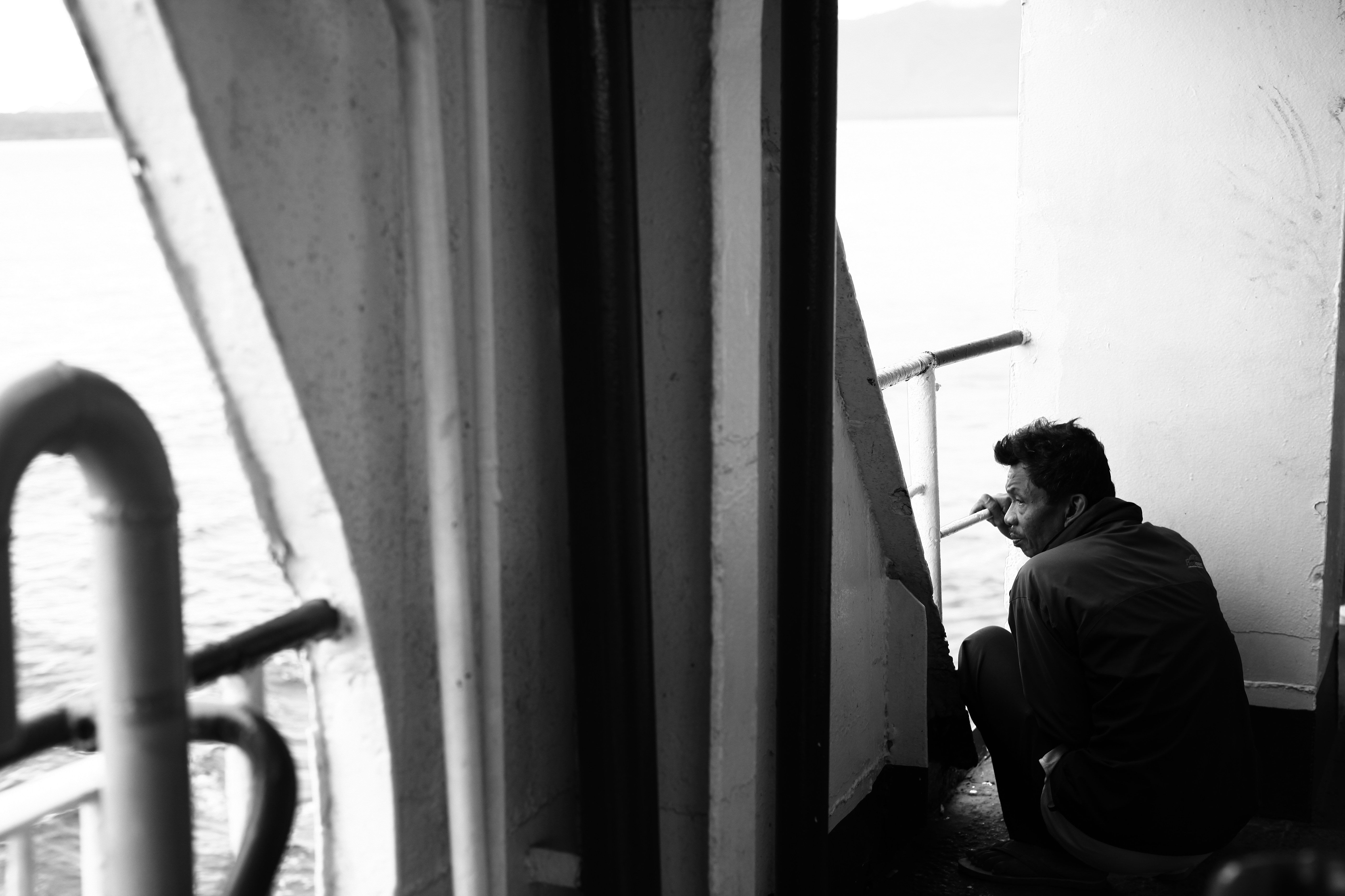 man in black shirt sitting on chair