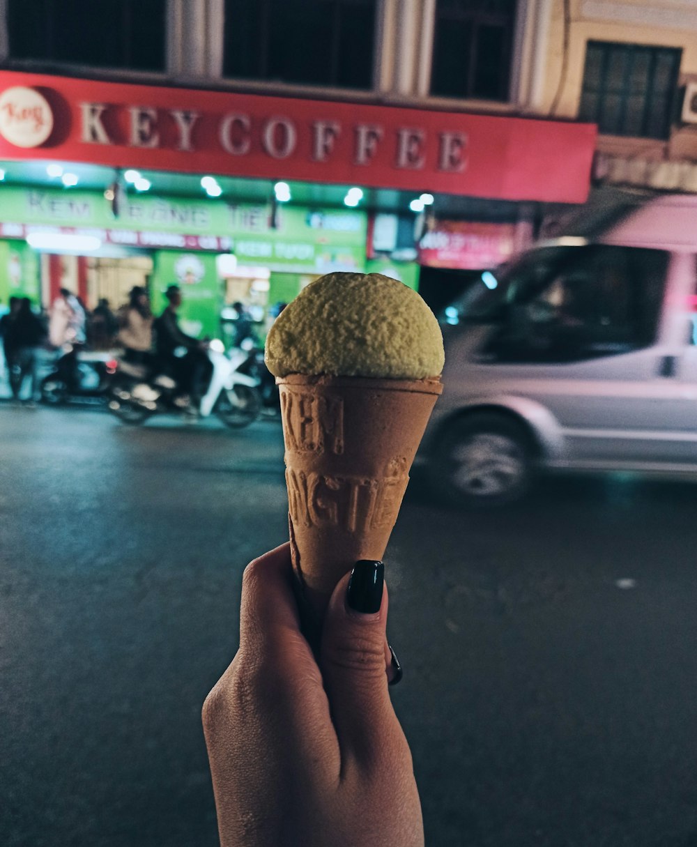 person holding brown ice cream cone