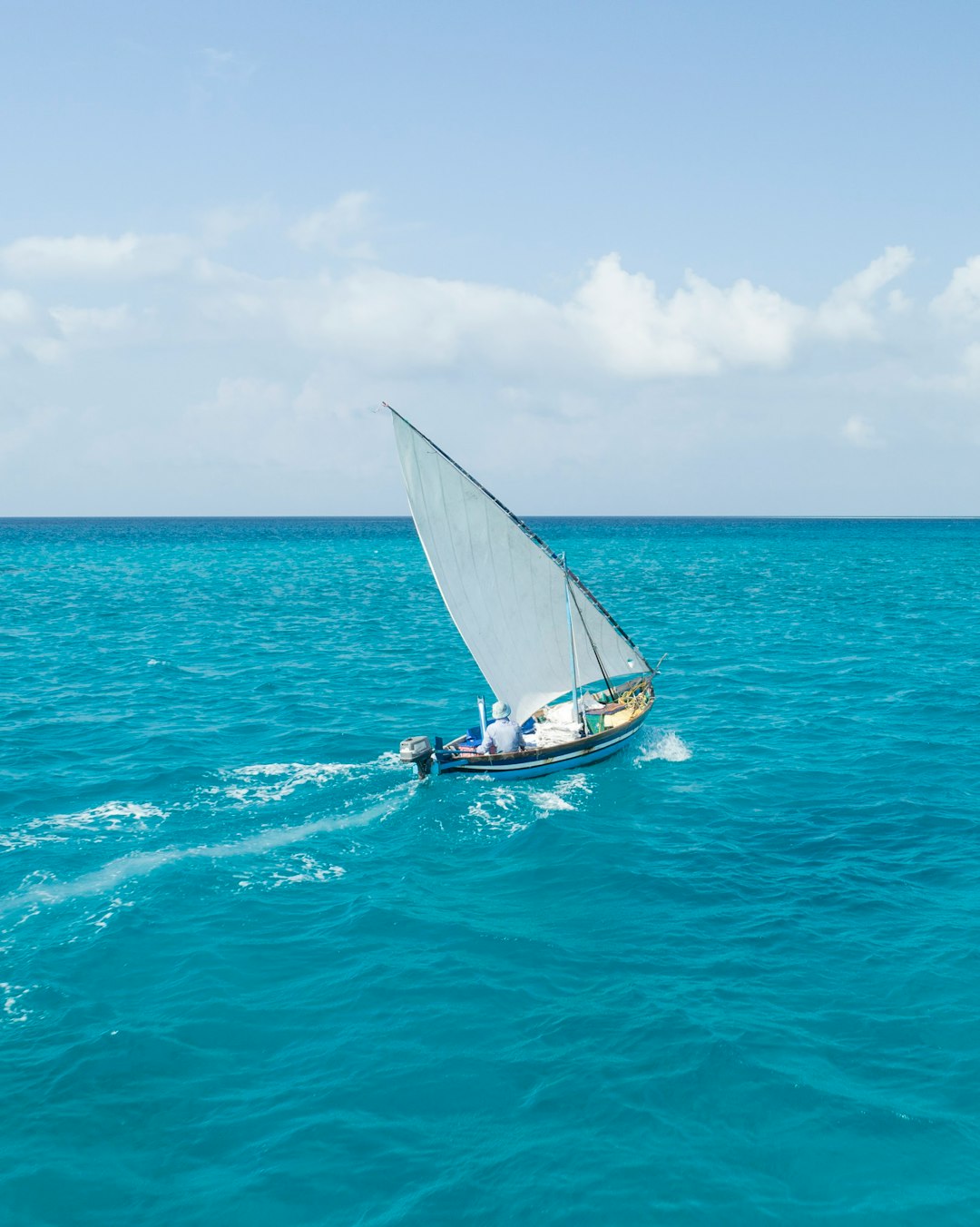 white sail boat on sea during daytime