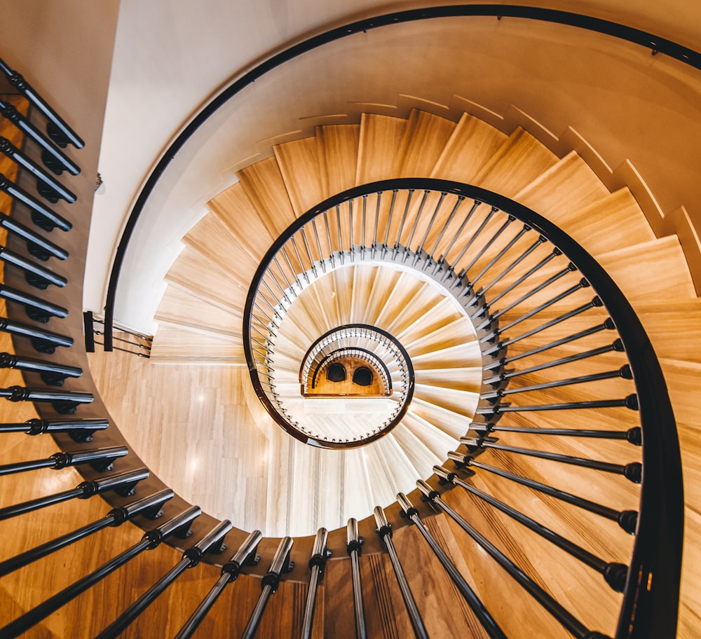 brown spiral staircase with brown wooden railings