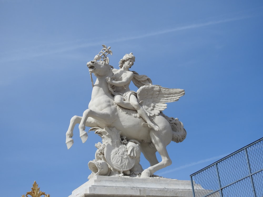 white angel statue under blue sky during daytime