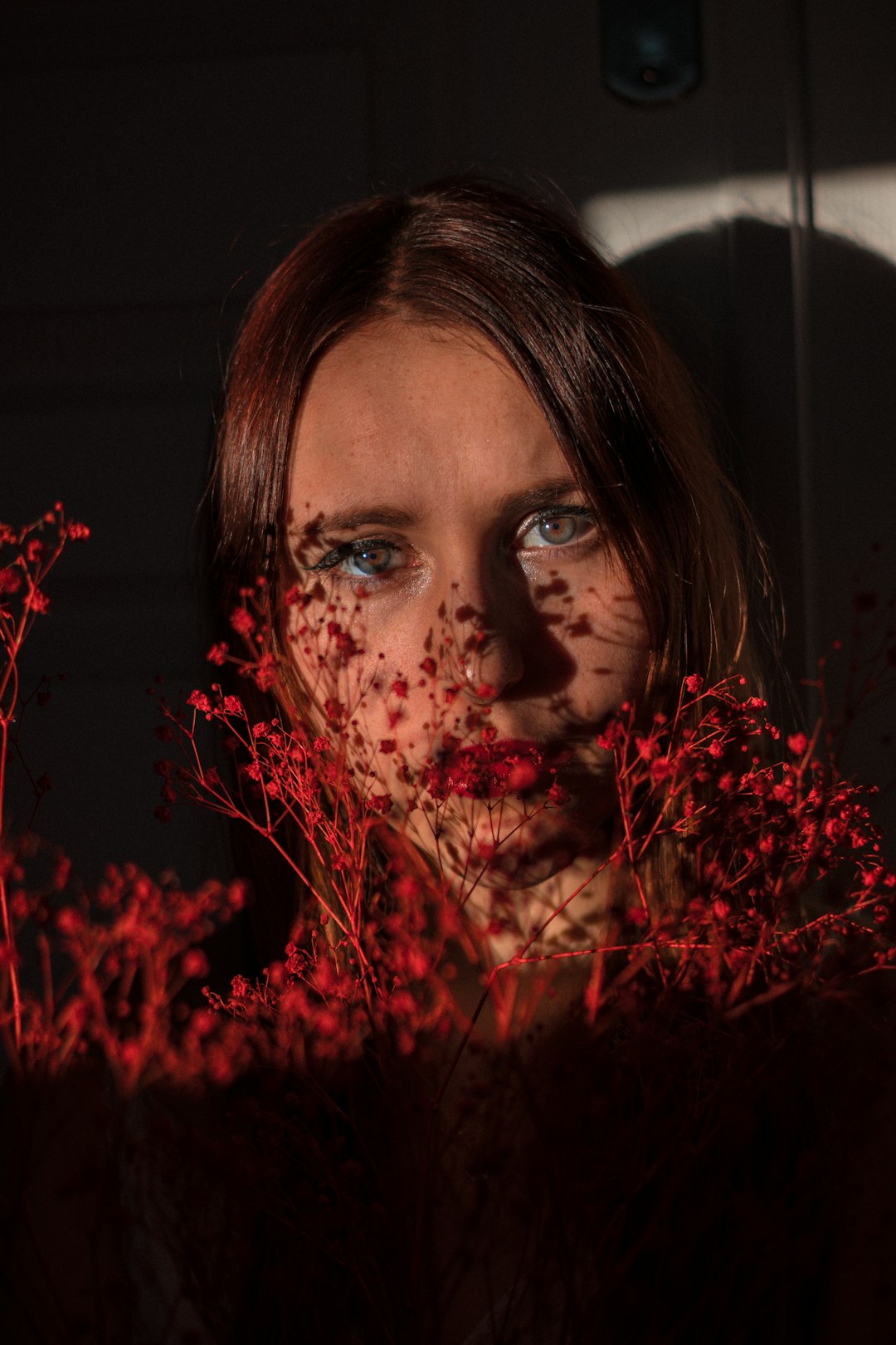 woman with red flowers on her face