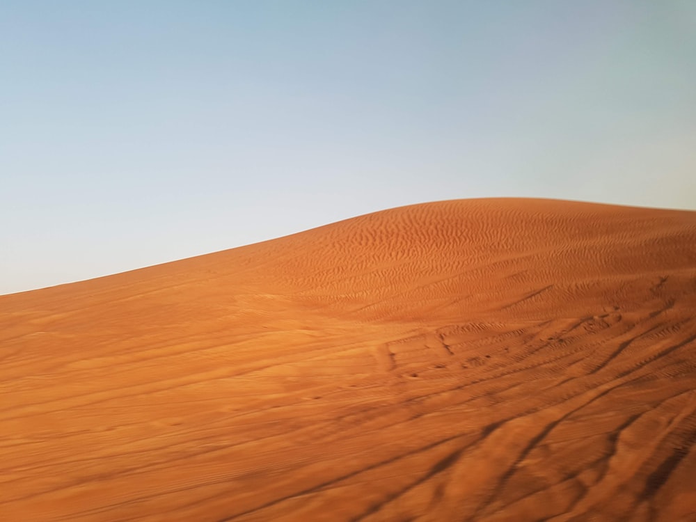 brown sand under blue sky during daytime