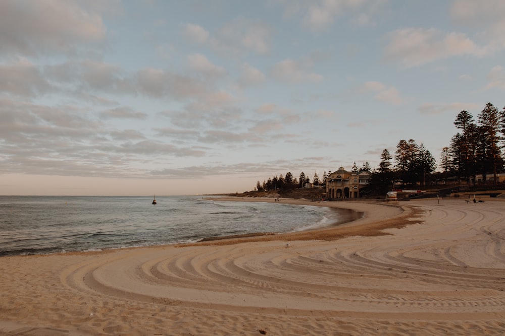 beach shore under cloudy sky during daytime