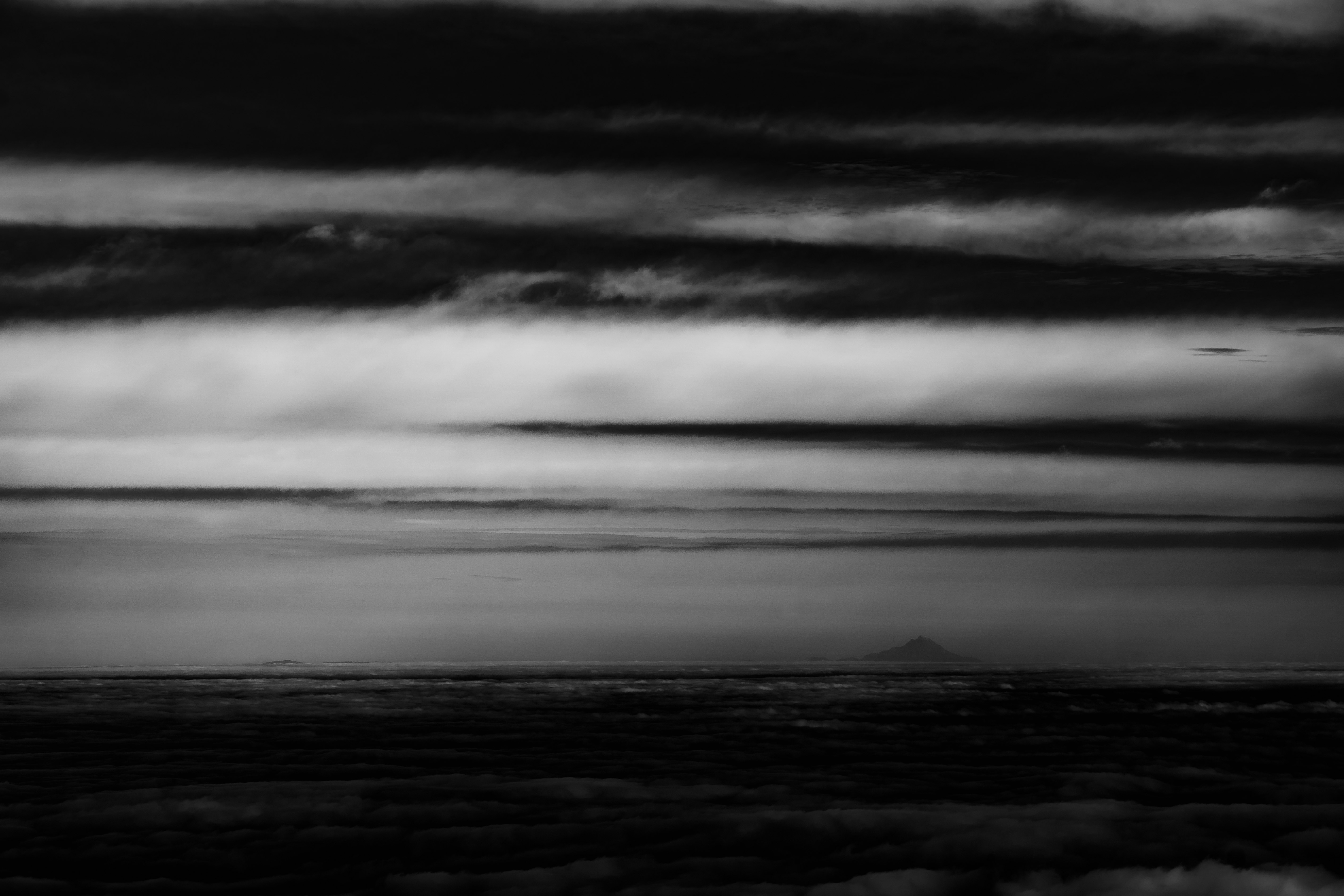grayscale photo of clouds over the sea