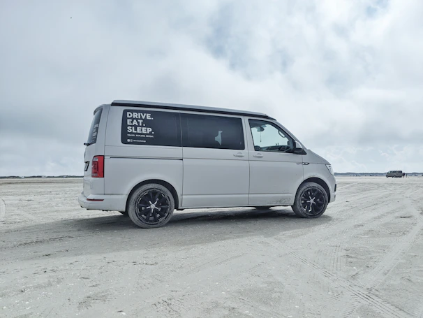 A delivery van from Shorenest unloading beach rentals right onto the soft sand for an easy setup.