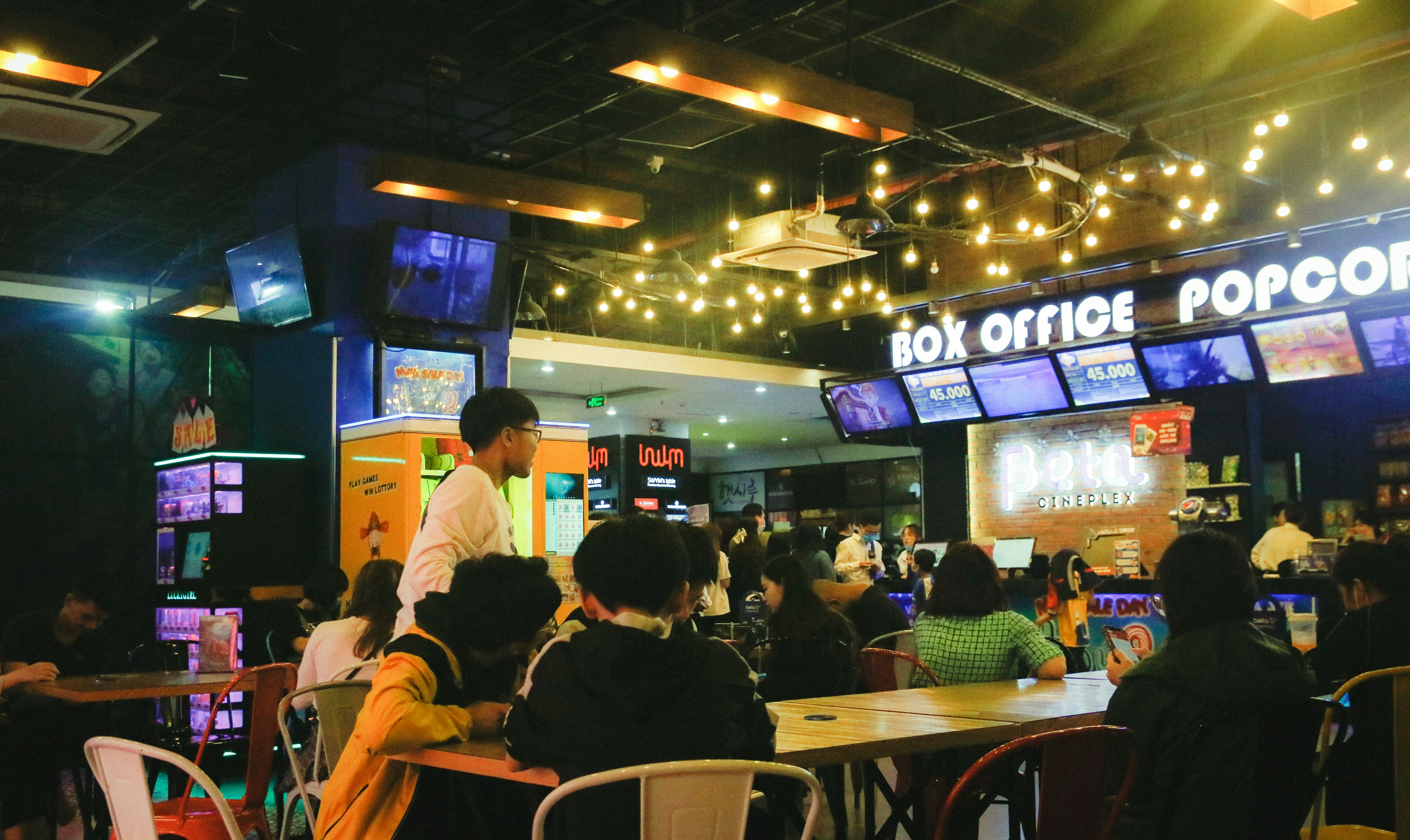 a group of people sitting at tables in a restaurant