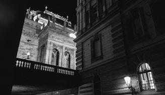 High-contrast photo of a restored heritage site entrance at dusk.